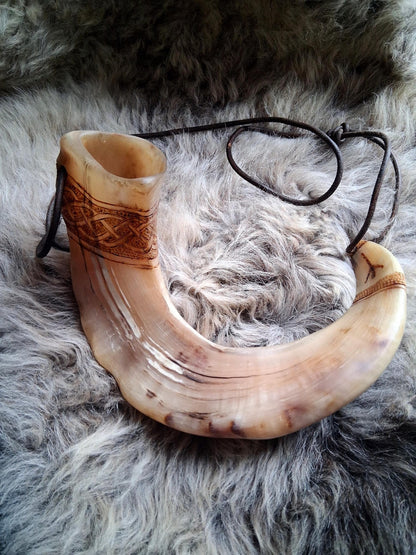 Hand-carved Orkney Boreray ram horn, full view with leather strap