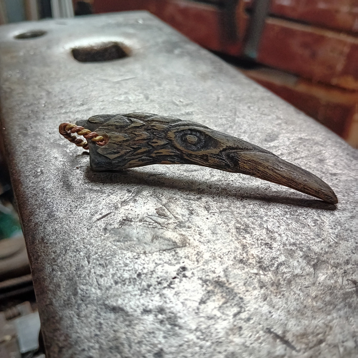 Hand-carved Orkney Boreray horn raven pendant with twisted brass hanging loop
