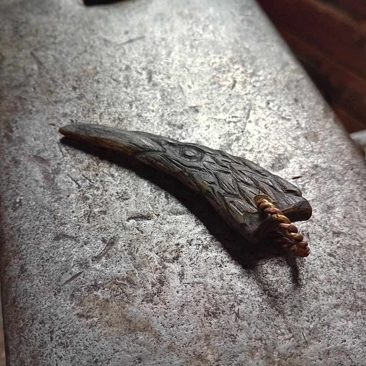 Hand-carved horn raven pendant from another angle