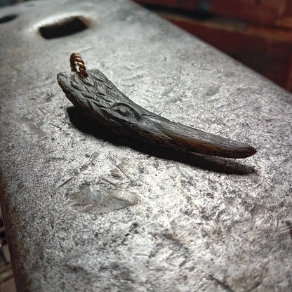 Boreray horn raven pendant showing curved beak and brass ring