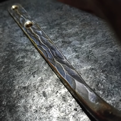 Close-up of textured solid brass wall hook stem and hammered surface