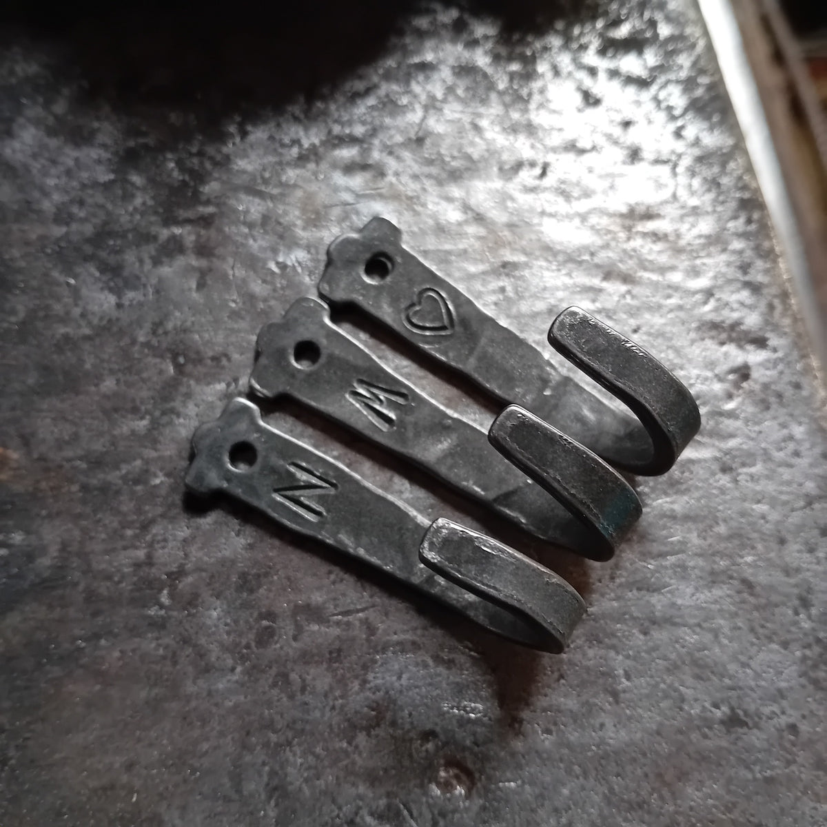 Hand-forged small steel hooks with letters and heart decoration