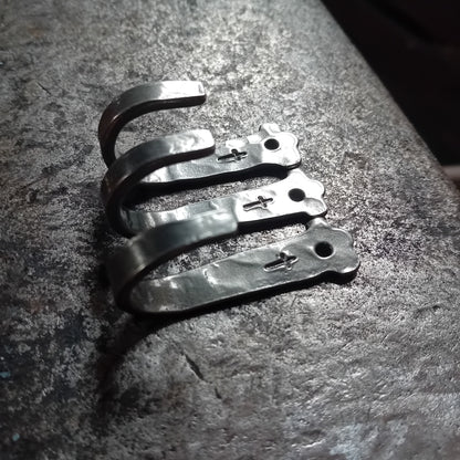 Three small hand-forged cross hooks showing curved profile