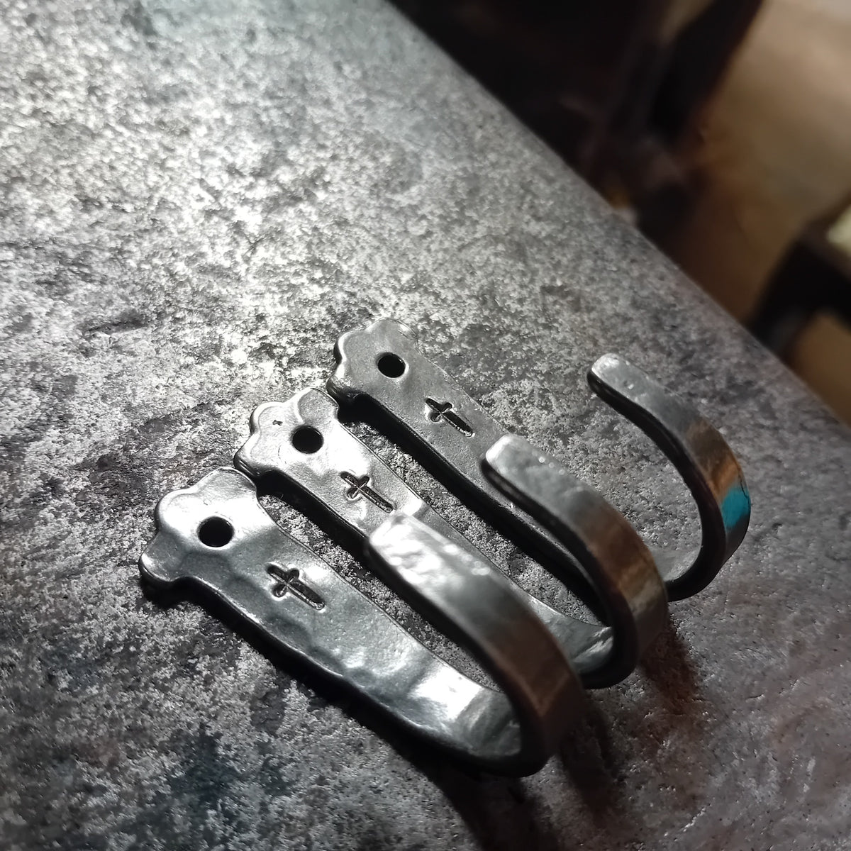 Close view of three handmade cross wall hooks