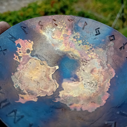 Close-up of hand-forged Rune Galaxy Bowl with brass nebula pattern and Elder Futhark runes
