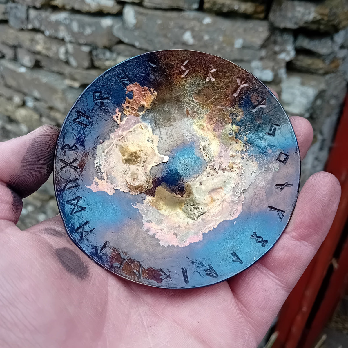 Small Rune Galaxy Bowl held in hand showing runes around the rim and blue brass galaxy finish
