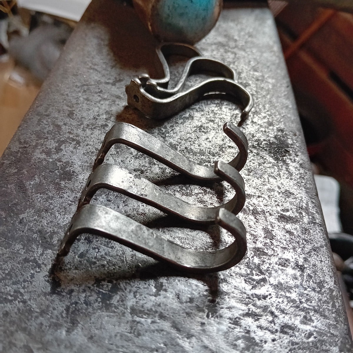 Side profile of hand-forged under-counter steel hooks